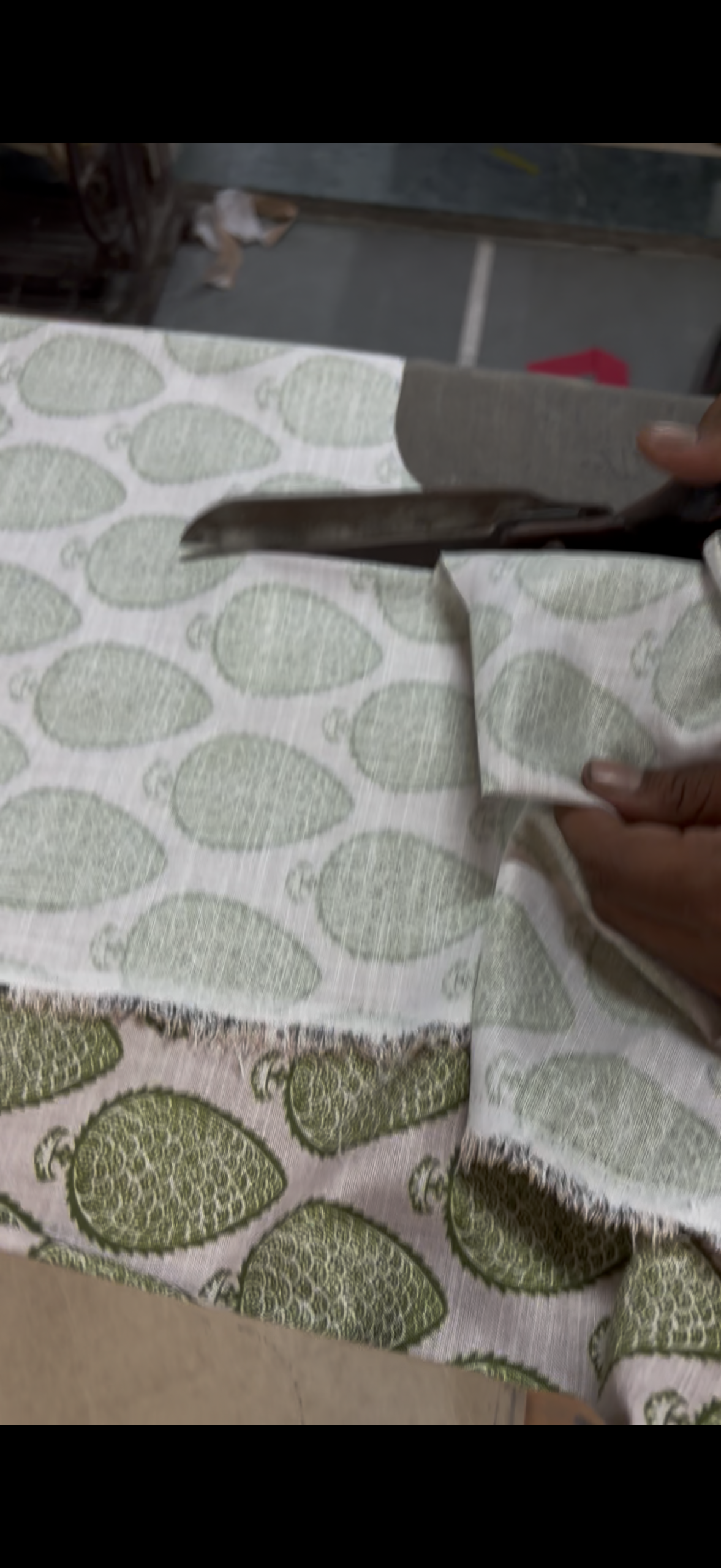 RAMYALAYANA garment pattern being cut by hand